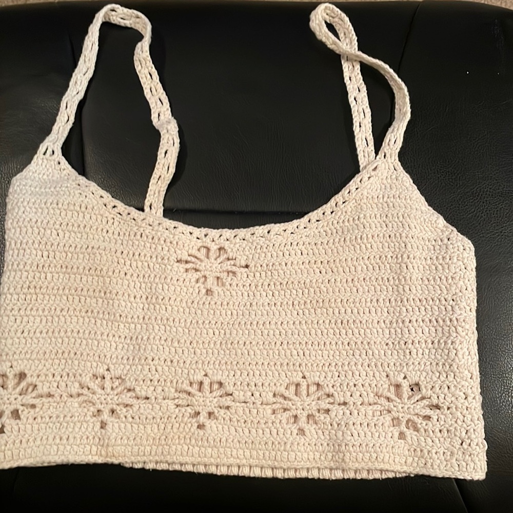Woman’s halter top in small crocheted with a decorative whole design with straps